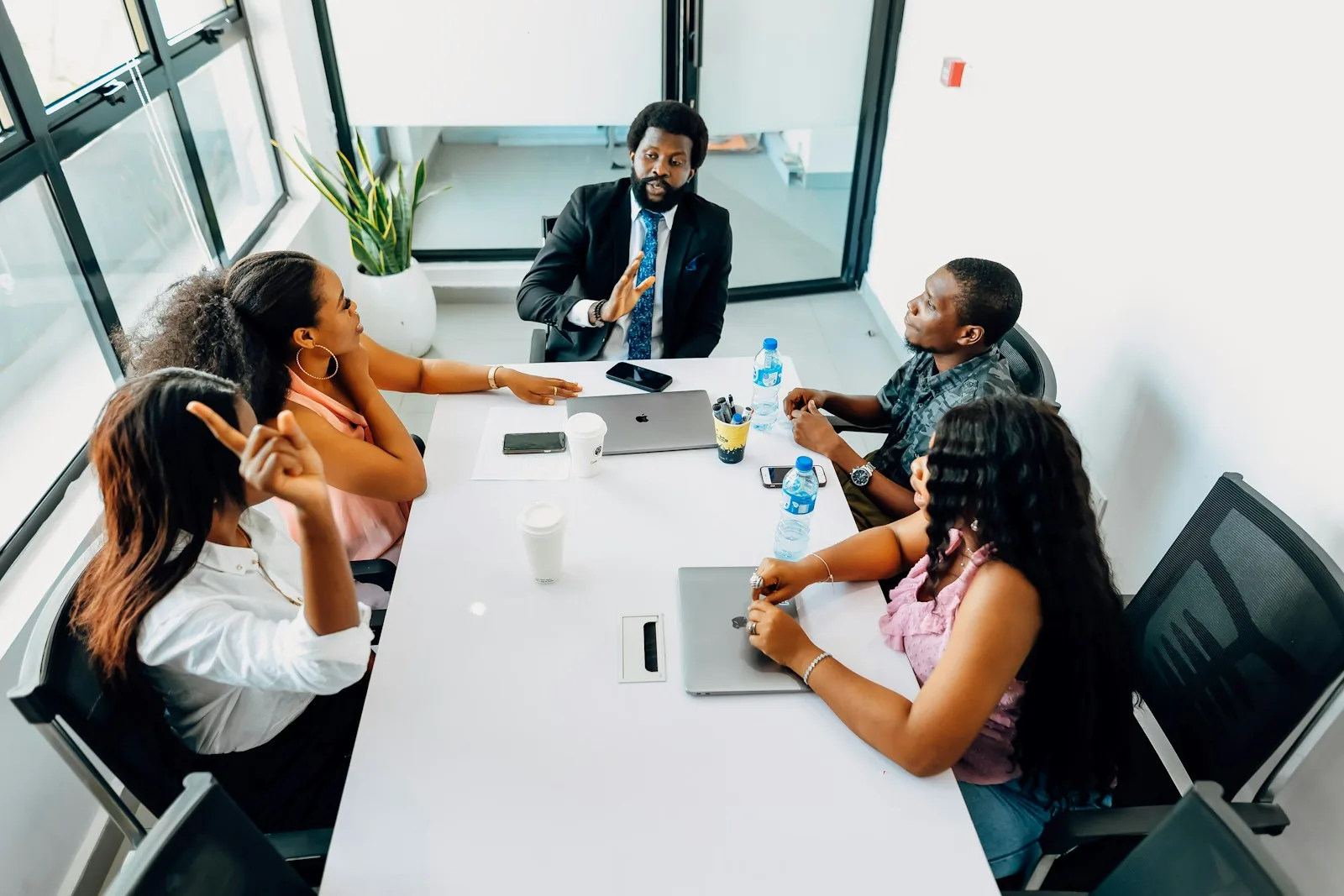 An adviser talking a client group through their options around a table